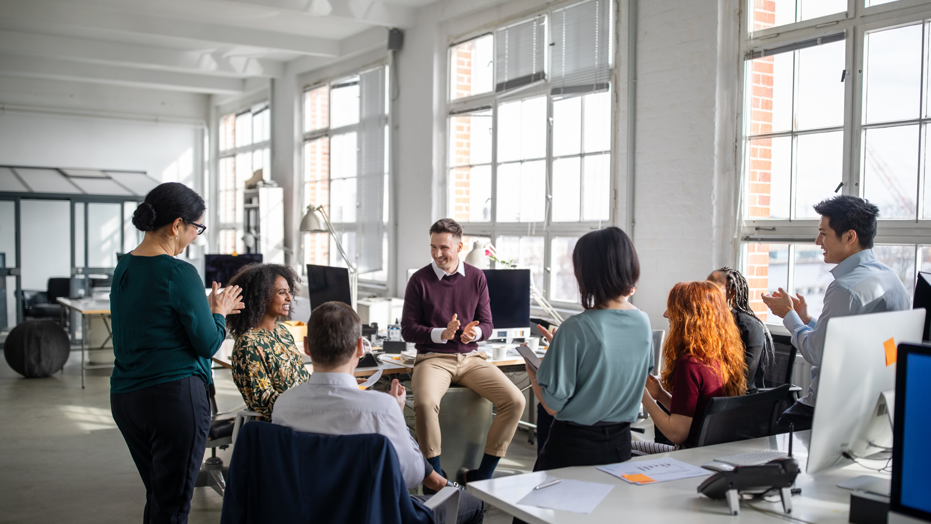 Colleagues clapping in a workplace