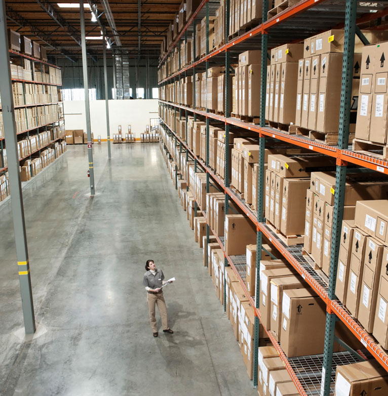 man documenting files in warehouse facility