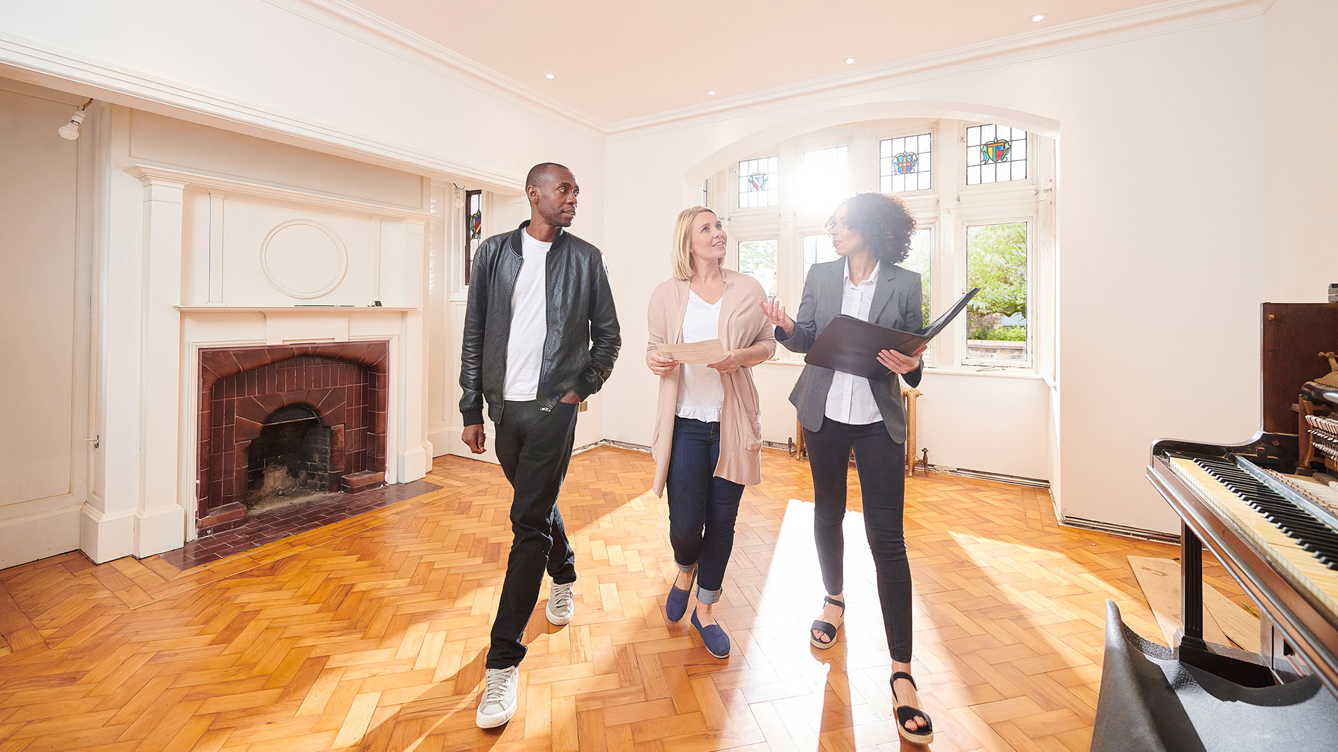 Couple being shown around an old style house by estate agent