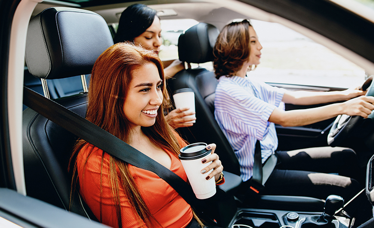 friends drinking coffee in a new car