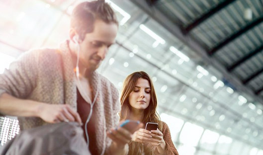 People using public wifi in train station