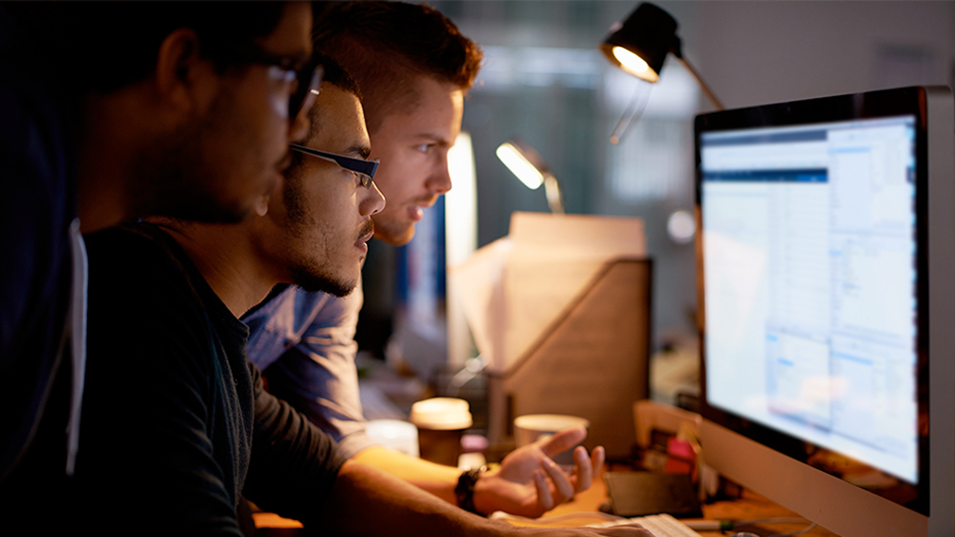 Young males checking computer security alert