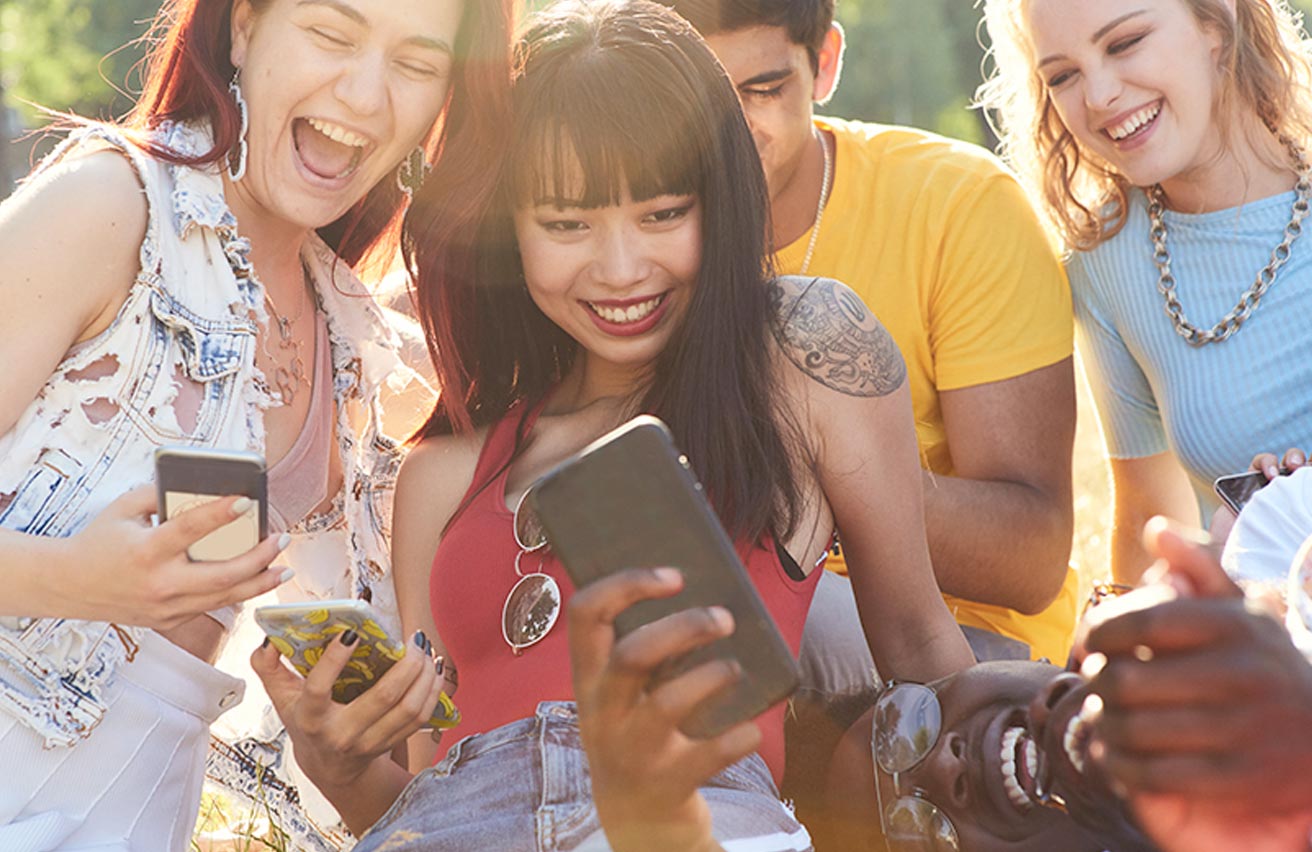 Youngsters laughing at something on social media