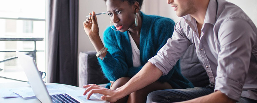 Couple looking at finances on laptop