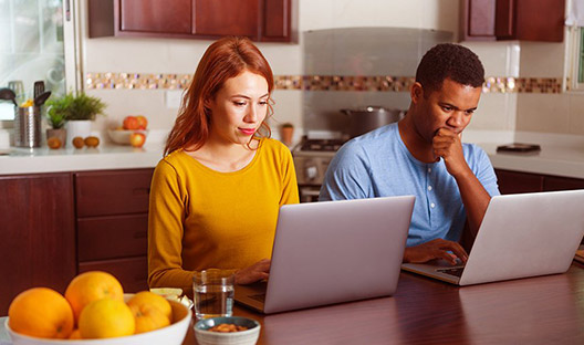 Couple working on laptops