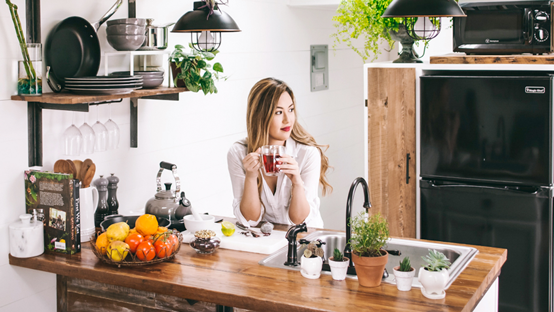 Female in kitchen drinking a herbal tea