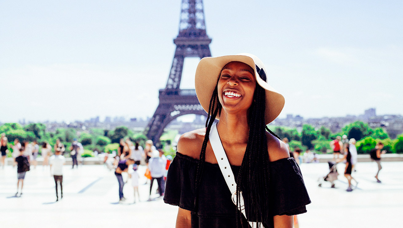 Young female standing infront of the Eiffel Tower