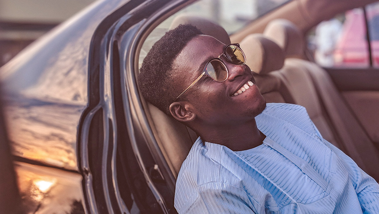 Young male sitting is his car