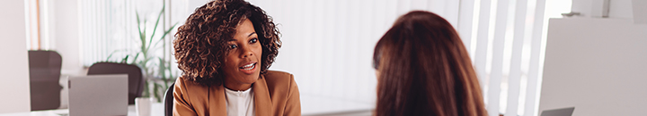 Young professional sitting with her financial advisor