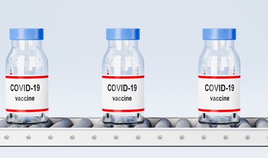 Covid-19 vaccines on a conveyor belt