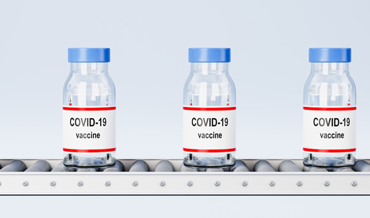 Covid-19 vaccines on a conveyor belt