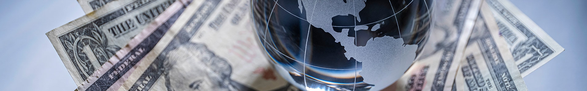 Globe paperweight sitting on top of notes