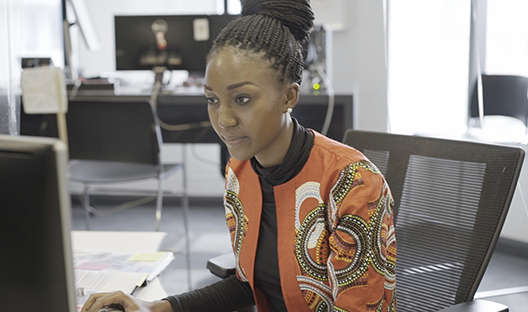 Investec employee at desk 