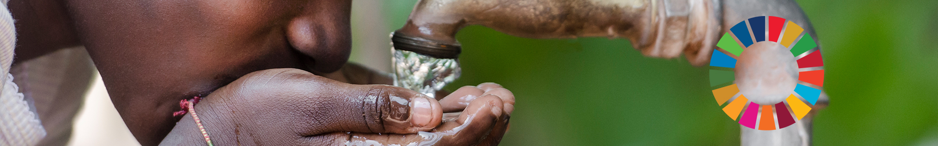Young girl drinking water from a tap