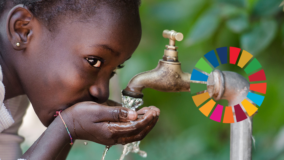 Young girl drinking water from a tap
