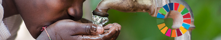 Young girl drinking water from a tap