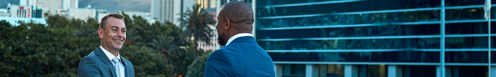 Business men meeting outside office as part of an alumni network
