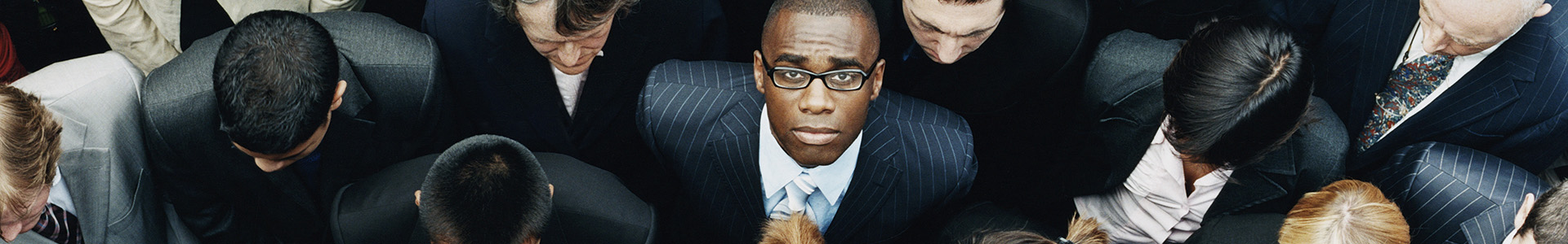 Business leader looking up in a crowd