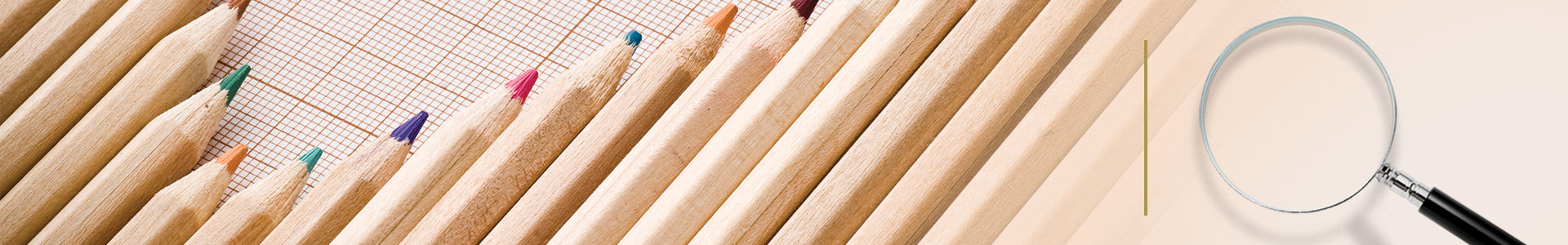 Row of coloured pencils on graph paper