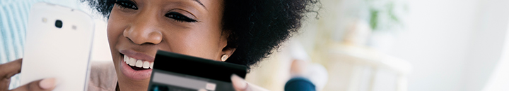 Credit score | Woman using credit card to pay on her cellphone