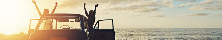 Vehicle finance | Two woman parked a cliff admiring the sea view 