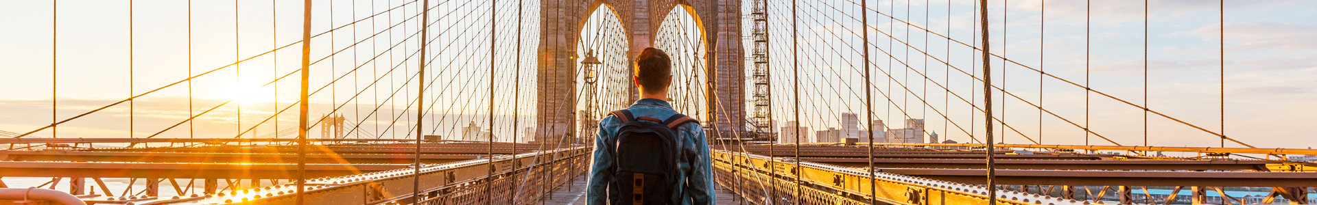Man walking across Brooklyn Bridge