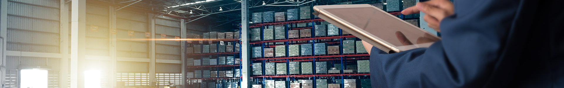 Warehouse background with man using a tablet