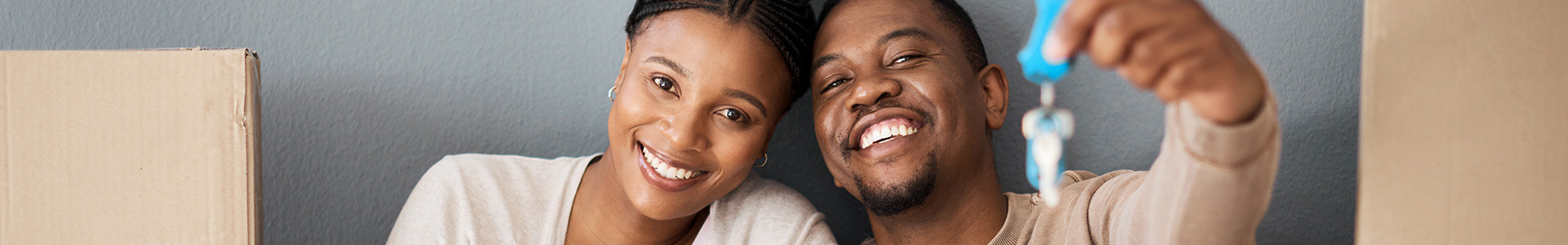 Young couple holding the keys to their first home