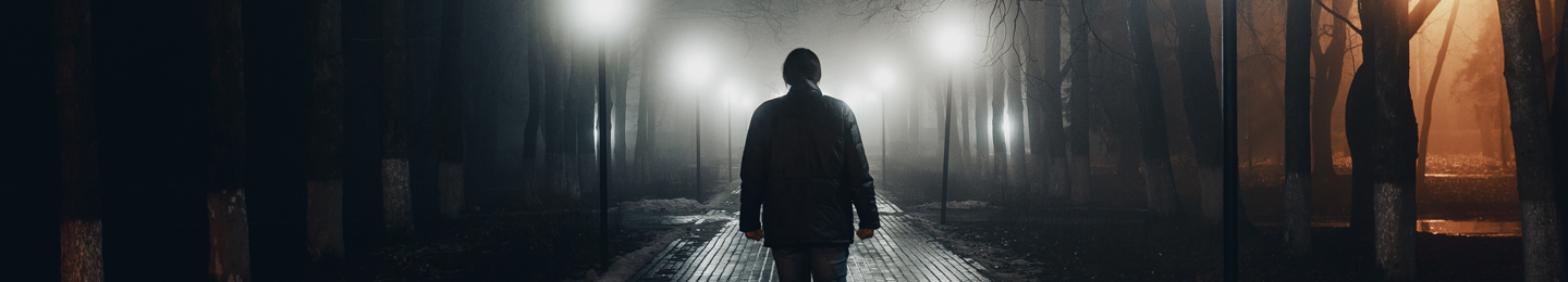 Man walking alone along a dark street