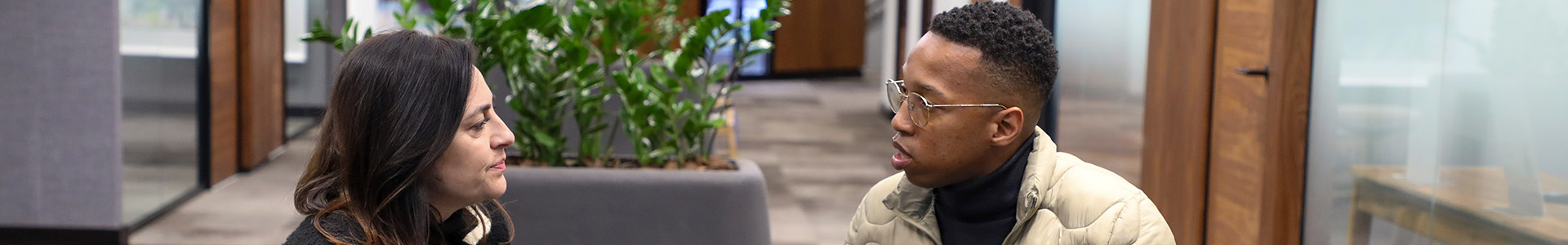 Katy Katopodis talking to Mpumelelo Mhlongo while sat down in Investec office