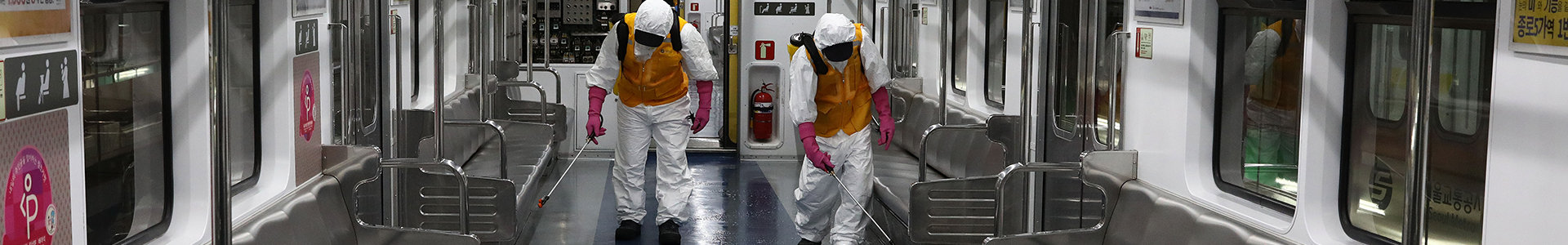 Disinfection workers wearing protective gear spray anti-septic solution against the coronavirus (COVID-19) in an subway at Seoul metro railway base