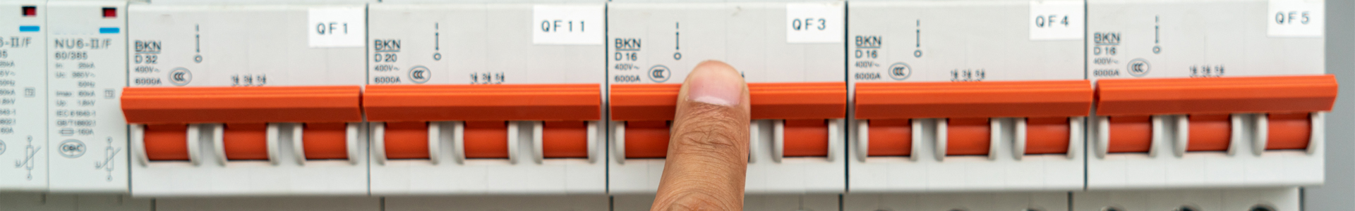 Finger on an electrical control panel