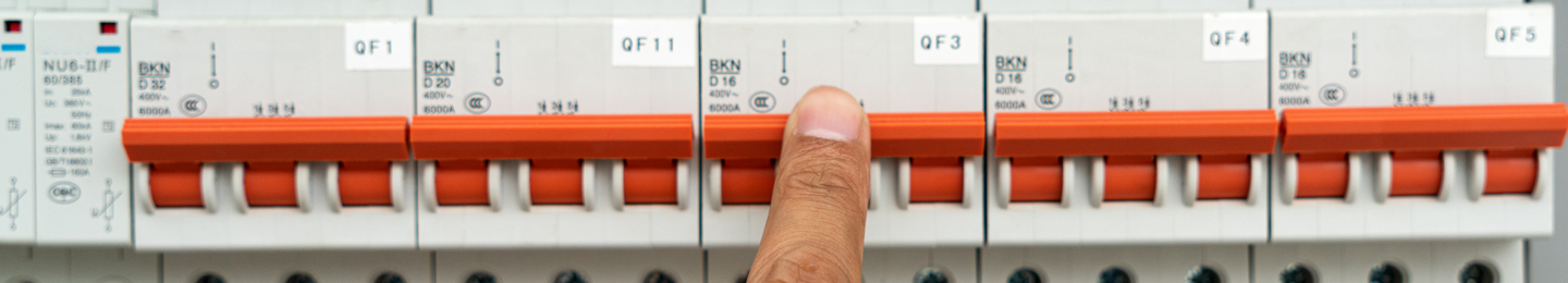 Finger on an electrical control panel