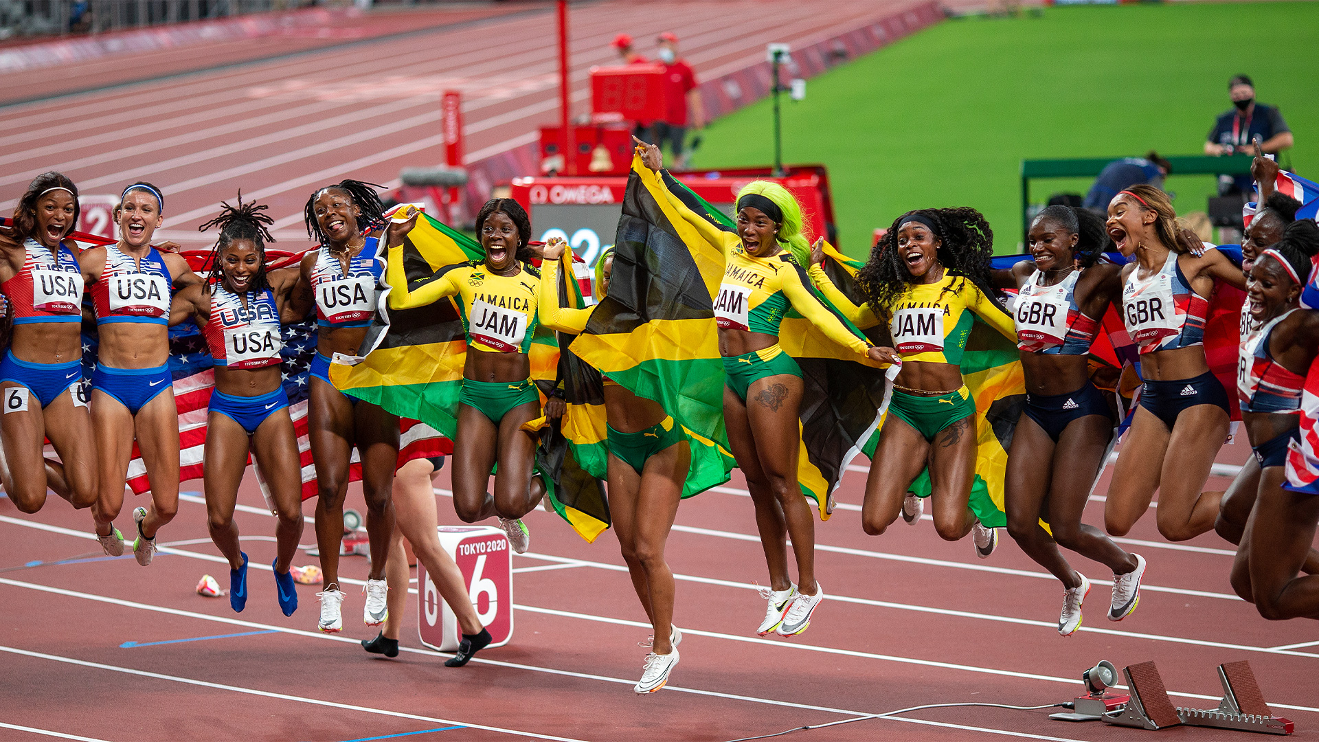 Jamaica, Great Britain and USA womens sprint teams celebrating together