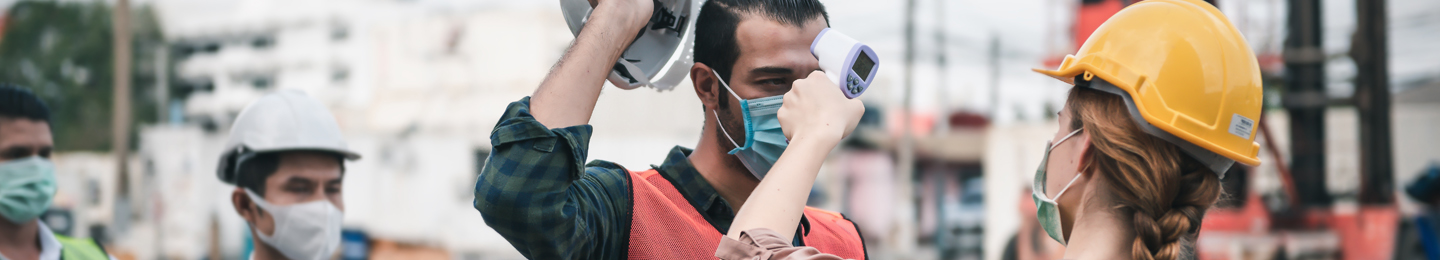 Woman checks the temperature of workers at a port