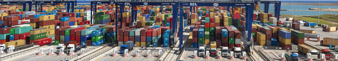 Shipping containers being loaded onto trucks