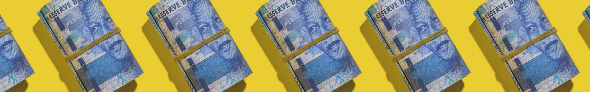 Row of rolled up R100 notes