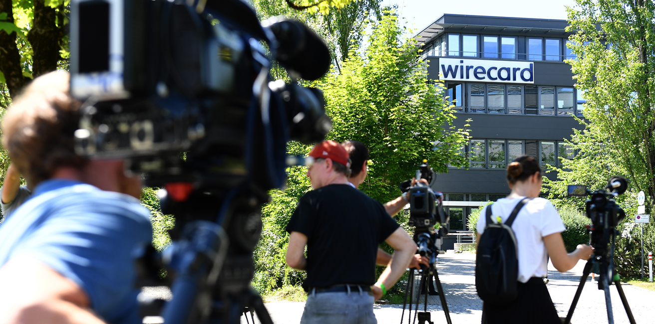 Media gathers outside the corporate headquarters of payments processor Wirecard during a raid by investigators on July 1, 2020 in Aschheim, Germany.