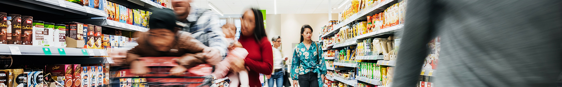 Shoppers going down the isle of a supermarket