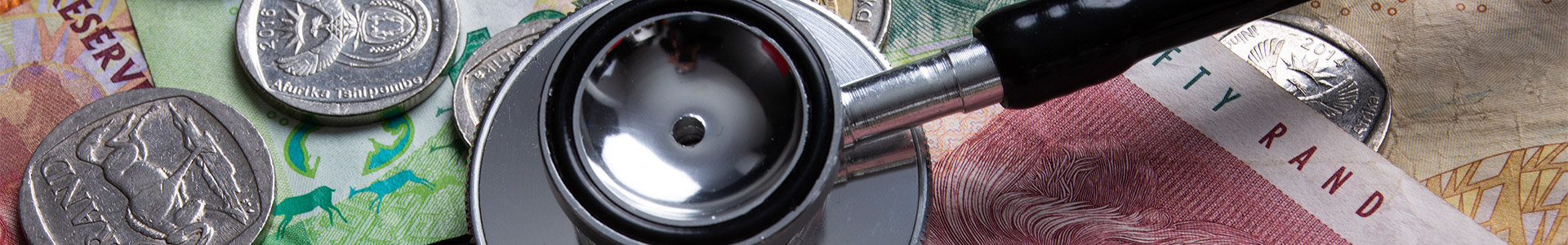 Stephoscope on top of Rand notes and coins