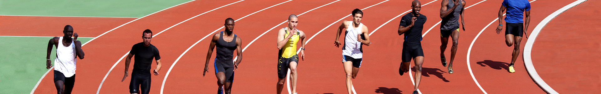 Group of athletes running around a track