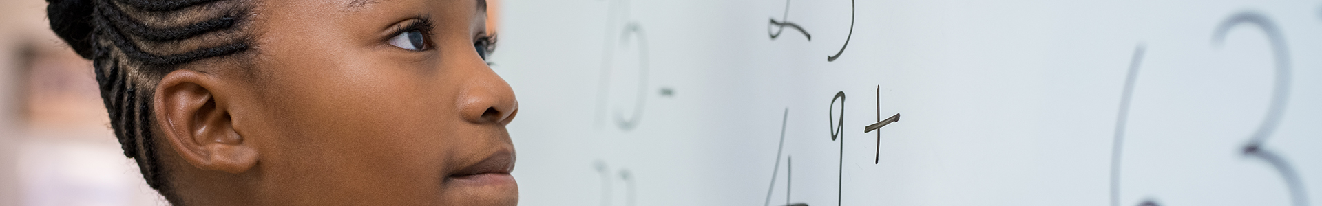 School girl writing on white board