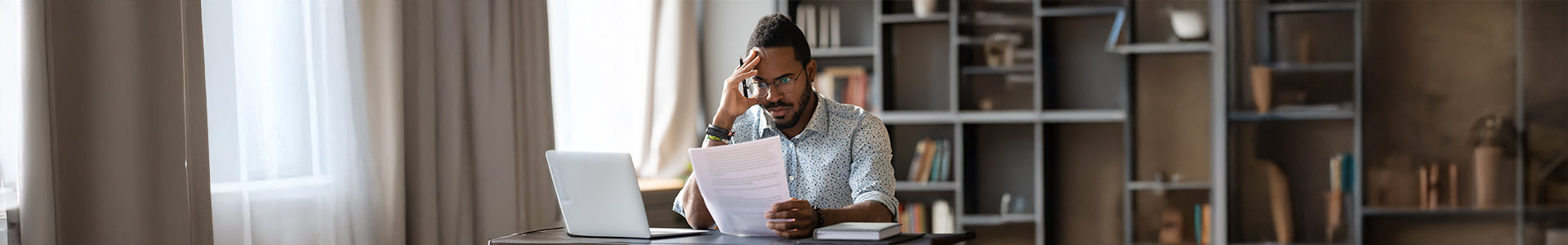 Man looking through documents at his desk