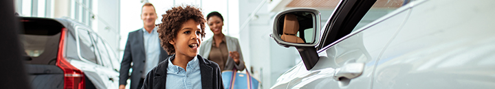 Family at a car dealership buying a car
