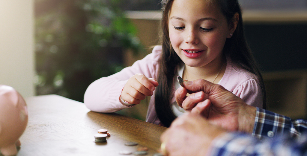 Investec Youth Account: Young girl counting coins