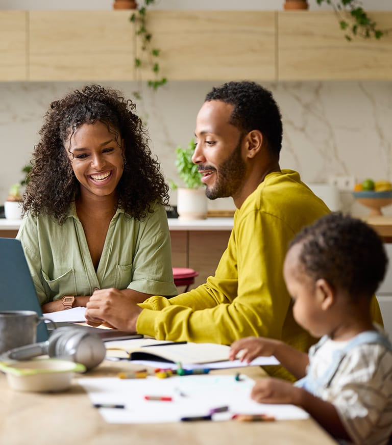Parents and child sitting in the kitchen