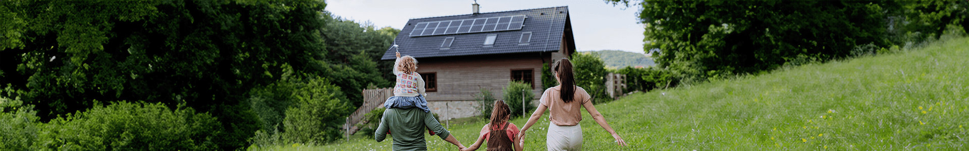 Family outside house with solar panels