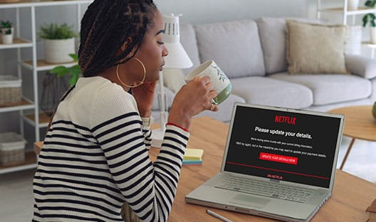 lady drinking coffee and seeing a Netflix scam