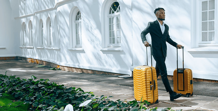 Male walking with travel bags
