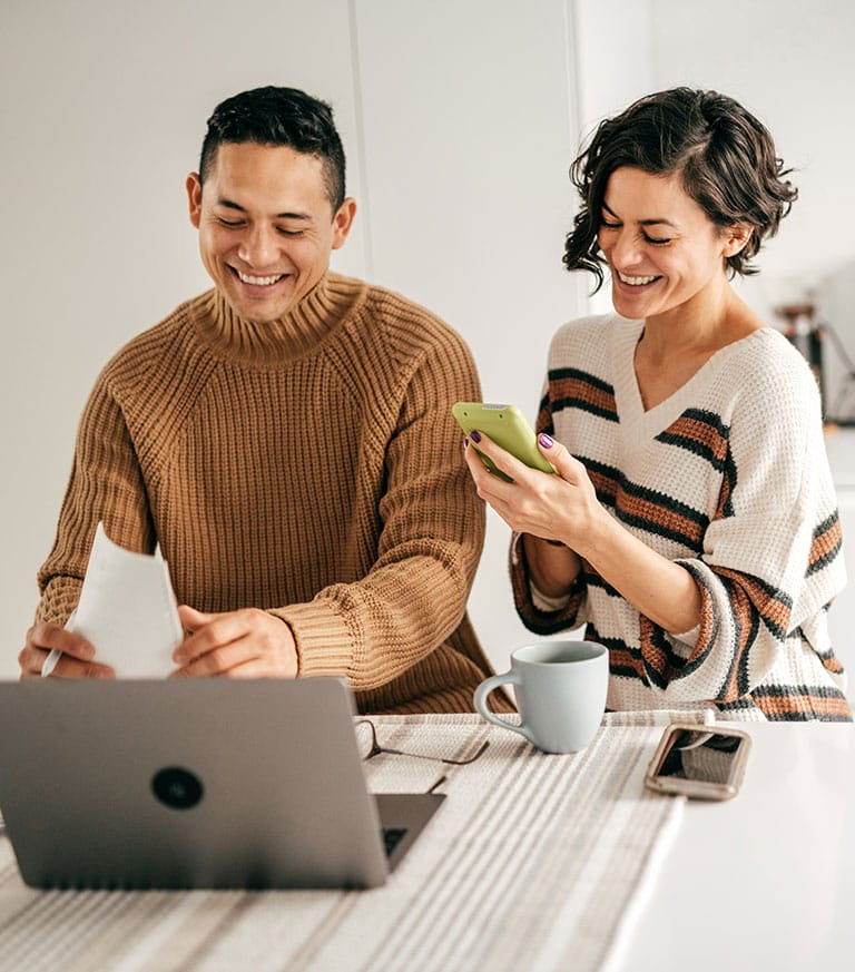couple making international payment on a laptop